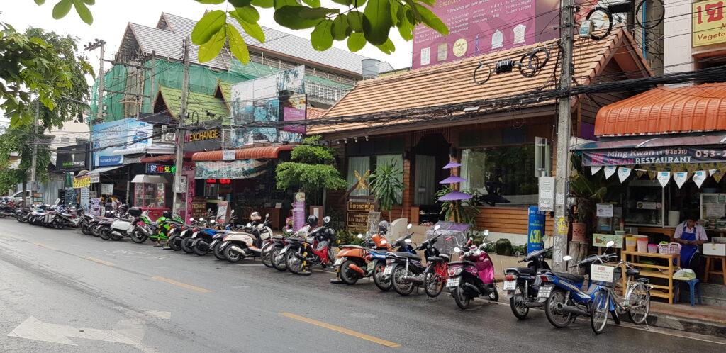Typical Chiang Mai street scene with the streets dominated by scooters