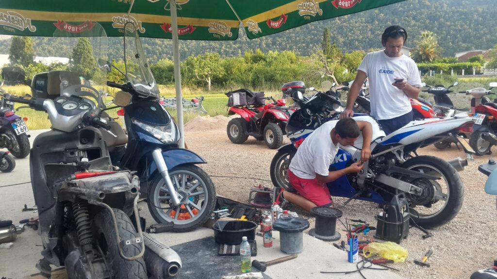 Futile attempts to get the bike going with salvaged parts in Bar, Montenegro